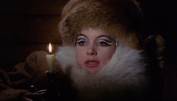 Movie still from “Women in Love” (1969), directed by Ken Russell – A woman in a fur hat and a candle; Close Up shot, High angle