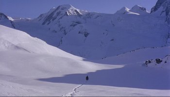 Movie still from “Women in Love” (1969), directed by Ken Russell – A person riding skis down a snow covered slope; Extreme Wide shot, High angle
