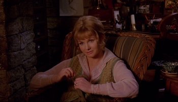 Movie still from “Women in Love” (1969), directed by Ken Russell – A woman sitting in a chair in a living room; Medium shot, High angle