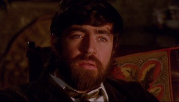 Movie still from “Women in Love” (1969), directed by Ken Russell – A person wearing a suit and tie; Close Up shot, High angle