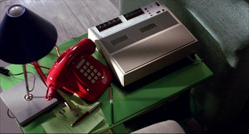 Movie still from “Women on the Verge of a Nervous Breakdown” (1988), directed by Pedro Almodóvar – A red telephone sitting on top of a green table; Extreme Close Up shot, High angle