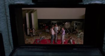 Movie still from “Women on the Verge of a Nervous Breakdown” (1988), directed by Pedro Almodóvar – A group of people standing in a room; Wide shot, High angle