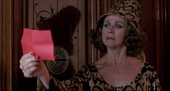 Movie still from “Women on the Verge of a Nervous Breakdown” (1988), directed by Pedro Almodóvar – An older woman holding a piece of paper in front of her face; Close Up shot, Over the shoulder angle