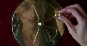 Movie still from “Women on the Verge of a Nervous Breakdown” (1988), directed by Pedro Almodóvar – A woman is looking into a mirror and holding a fan; Extreme Close Up shot, Overhead angle