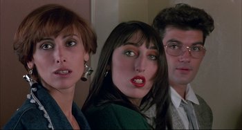 Movie still from “Women on the Verge of a Nervous Breakdown” (1988), directed by Pedro Almodóvar – A group of people standing next to each other in a room; Close Up shot, Low angle