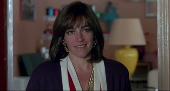 Movie still from “Women on the Verge of a Nervous Breakdown” (1988), directed by Pedro Almodóvar – A person wearing a necklace; Close Up shot, Over the shoulder angle