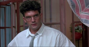 Movie still from “Women on the Verge of a Nervous Breakdown” (1988), directed by Pedro Almodóvar – A man wearing a white shirt and a tie; Close Up shot, Low angle