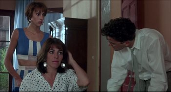 Movie still from “Women on the Verge of a Nervous Breakdown” (1988), directed by Pedro Almodóvar – A woman in polka dot shirt looking at a man in a white shirt; Medium shot, Over the shoulder angle