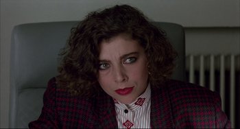 Movie still from “Women on the Verge of a Nervous Breakdown” (1988), directed by Pedro Almodóvar – A person with curly hair wearing a jacket; Close Up shot, High angle