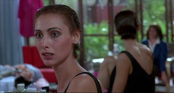 Movie still from “Women on the Verge of a Nervous Breakdown” (1988), directed by Pedro Almodóvar – A woman in a black top is looking at the camera; Close Up shot, Over the shoulder angle