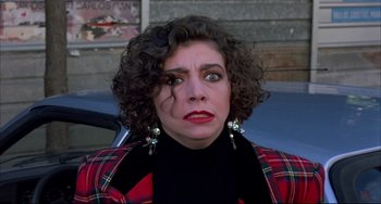 Movie still from “Women on the Verge of a Nervous Breakdown” (1988), directed by Pedro Almodóvar – A person wearing a plaid jacket; Close Up shot, Over the shoulder angle