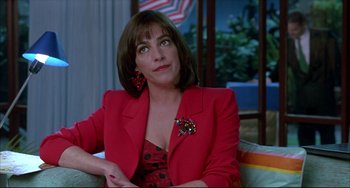 Movie still from “Women on the Verge of a Nervous Breakdown” (1988), directed by Pedro Almodóvar – A woman in a red jacket sitting on a couch; Close Up shot, Over the shoulder angle