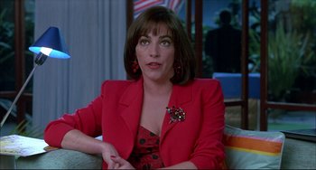 Movie still from “Women on the Verge of a Nervous Breakdown” (1988), directed by Pedro Almodóvar – A woman in a red jacket sitting on a couch; Close Up shot, Over the shoulder angle
