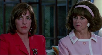 Movie still from “Women on the Verge of a Nervous Breakdown” (1988), directed by Pedro Almodóvar – A couple of women sitting next to each other on a couch; Close Up shot, Over the shoulder angle