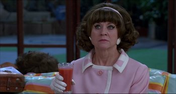 Movie still from “Women on the Verge of a Nervous Breakdown” (1988), directed by Pedro Almodóvar – An older woman holding a glass of orange juice; Close Up shot, Over the shoulder angle