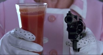 Movie still from “Women on the Verge of a Nervous Breakdown” (1988), directed by Pedro Almodóvar – A camera is taking a picture of a glass of orange juice; Extreme Close Up shot, High angle