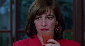 Movie still from “Women on the Verge of a Nervous Breakdown” (1988), directed by Pedro Almodóvar – A person holding a glass of juice; Close Up shot, High angle