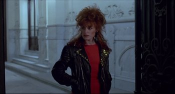 Movie still from “Women on the Verge of a Nervous Breakdown” (1988), directed by Pedro Almodóvar – A woman in a red dress and a leather jacket; Medium shot, Low angle