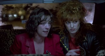 Movie still from “Women on the Verge of a Nervous Breakdown” (1988), directed by Pedro Almodóvar – A couple of women sitting next to each other in a car; Close Up shot, Over the shoulder angle