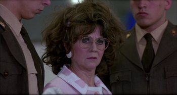 Movie still from “Women on the Verge of a Nervous Breakdown” (1988), directed by Pedro Almodóvar – An older woman wearing glasses and a pink and white striped shirt; Close Up shot, Low angle