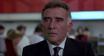 Movie still from “Women on the Verge of a Nervous Breakdown” (1988), directed by Pedro Almodóvar – An older man wearing a suit and a tie; Close Up shot, Low angle