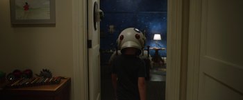 Movie still from “Wonder” (2017), directed by Stephen Chbosky – A person wearing a helmet in a room; Medium shot, Over the shoulder angle