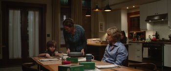 Movie still from “Wonder” (2017), directed by Stephen Chbosky – A woman and two children are sitting at a table; Medium shot, Over the shoulder angle