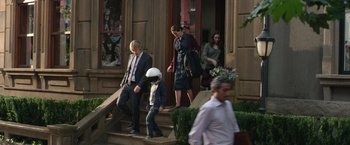 Movie still from “Wonder” (2017), directed by Stephen Chbosky – A group of people walking down the steps of a building; Wide shot, Over the shoulder angle
