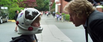 Movie still from “Wonder” (2017), directed by Stephen Chbosky – A man and a boy wearing a motorcycle helmet on the sidewalk; Close Up shot, Over the shoulder angle
