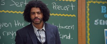 Movie still from “Wonder” (2017), directed by Stephen Chbosky – A man in a suit standing in front of a chalkboard; Close Up shot, Low angle