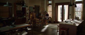 Movie still from “Wonder” (2017), directed by Stephen Chbosky – A person sitting at a table in a room; Wide shot, High angle
