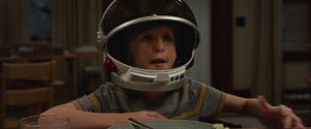 Movie still from “Wonder” (2017), directed by Stephen Chbosky – A young boy wearing a space helmet while sitting at a table; Close Up shot, Over the shoulder angle
