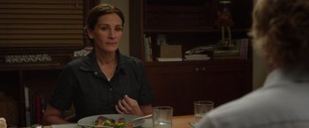 Movie still from “Wonder” (2017), directed by Stephen Chbosky – A woman sitting at a table with a plate of food in front of her; Close Up shot, Over the shoulder angle