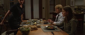 Movie still from “Wonder” (2017), directed by Stephen Chbosky – A man sitting at a table with a plate of food; Medium shot, Over the shoulder angle