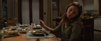 Movie still from “Wonder” (2017), directed by Stephen Chbosky – A woman sitting at a table with a plate of food in front of her eating utensils; Medium shot, High angle