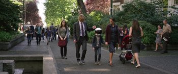 Movie still from “Wonder” (2017), directed by Stephen Chbosky – A group of people walking down a street; Wide shot, Over the shoulder angle