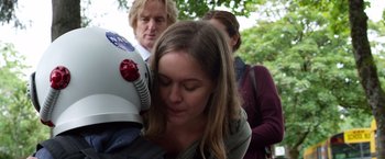Movie still from “Wonder” (2017), directed by Stephen Chbosky – A woman with her head on top of a helmet; Close Up shot, Over the shoulder angle