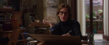 Movie still from “Wonder” (2017), directed by Stephen Chbosky – A woman sitting at a table writing on a piece of paper; Medium shot, Over the shoulder angle