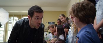Movie still from “Wonder” (2017), directed by Stephen Chbosky – A group of people in a room with a man talking; Close Up shot, Over the shoulder angle