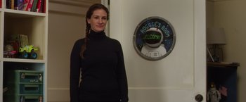 Movie still from “Wonder” (2017), directed by Stephen Chbosky – A woman standing in front of a wall with a sign on it; Medium shot, Over the shoulder angle