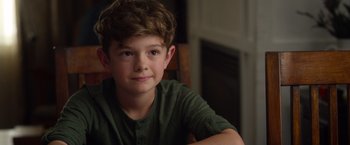 Movie still from “Wonder” (2017), directed by Stephen Chbosky – A young boy sitting at a table in front of a window; Close Up shot, Over the shoulder angle
