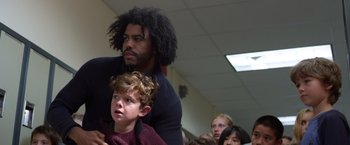 Movie still from “Wonder” (2017), directed by Stephen Chbosky – A man and a boy are standing in a room together; Medium shot, Low angle