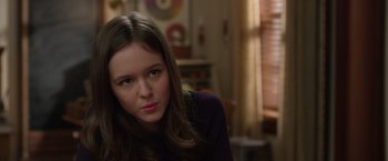 Movie still from “Wonder” (2017), directed by Stephen Chbosky – A young woman sitting in front of a window looking at the camera; Close Up shot, Over the shoulder angle