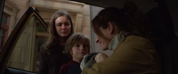 Movie still from “Wonder” (2017), directed by Stephen Chbosky – A group of people standing next to each other in a room; Close Up shot, Over the shoulder angle