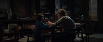 Movie still from “Wonder” (2017), directed by Stephen Chbosky – A man and a boy sitting at a dining room table; Medium shot, Over the shoulder angle