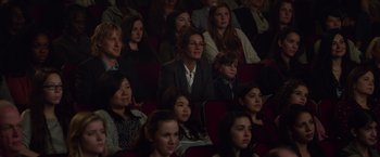 Movie still from “Wonder” (2017), directed by Stephen Chbosky – A group of people sitting in a row of seats; Wide shot, High angle