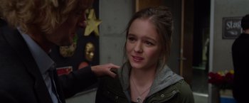 Movie still from “Wonder” (2017), directed by Stephen Chbosky – A young woman getting her hair done by a man; Close Up shot, Over the shoulder angle