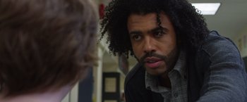 Movie still from “Wonder” (2017), directed by Stephen Chbosky – A person with curly hair and a beard; Close Up shot, Over the shoulder angle