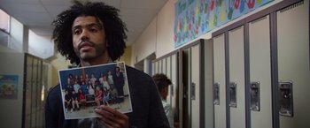 Movie still from “Wonder” (2017), directed by Stephen Chbosky – A man holding a picture of himself and his family; Medium shot, Over the shoulder angle