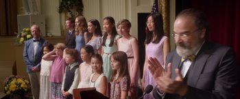 Movie still from “Wonder” (2017), directed by Stephen Chbosky – A group of young people standing next to each other in front of a microphone; Medium shot, Over the shoulder angle